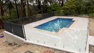Frameless glass pool fence and steel blade fencing.