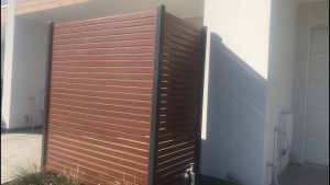 Privacy screen At Christies Beach. Wood look slats with powder coated colour posts