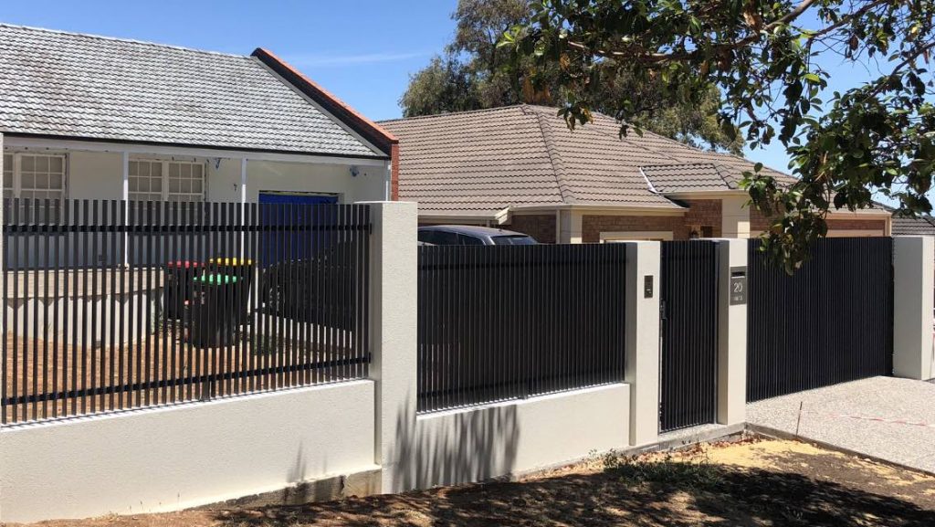 Steel blade tubular fencing in existing brick pillars.