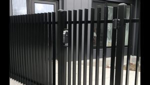 Aluminum blade fencing, with custom lock, supplied by customer. At Aldgate.