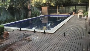 Frameless glass pool fencing on a timber deck.