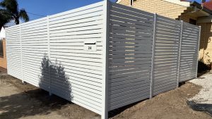 Aluminium slat privacy fence with integrated letter box